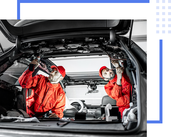 two mechanic doing maintenance inside the vehicle